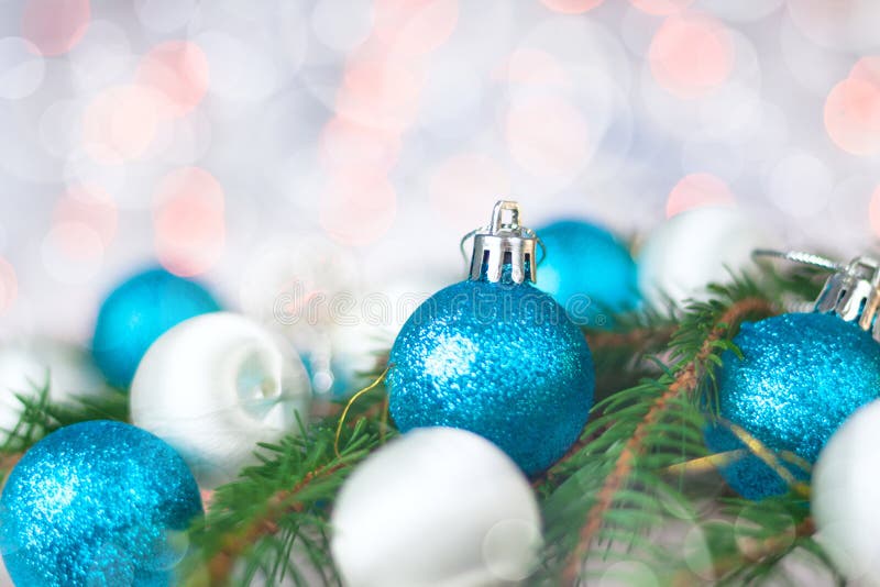 Christmas card with balls, spruce twig and bokeh