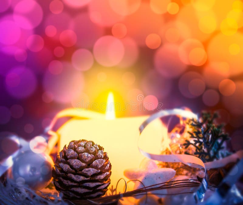 Christmas card with candle, spruce buds and scenery on bokeh background