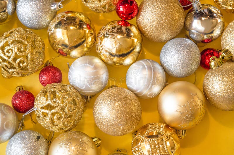 Christmas colored balls on yellow background