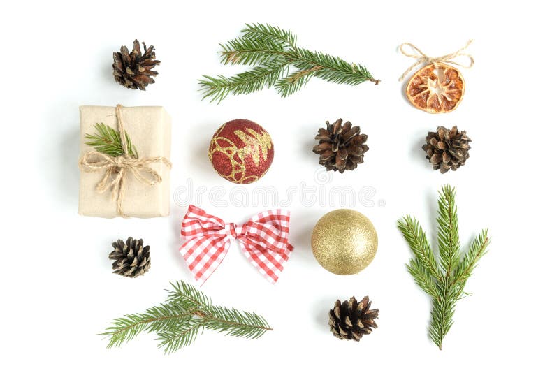 Christmas composition of Christmas balls, gift box, cones and fir branches isolated on white background.
