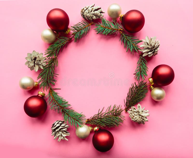 Christmas composition. Christmas wreath with fir branches and red baubles on pink background. Christmas, winter, new year concept. stock images Christmas composition. Christmas wreath with fir branches and red baubles on pink background. Christmas, winter, new year concept. stock images