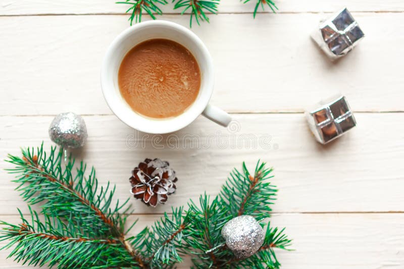 Christmas composition - coffee cup and Christmas tree branches on white wooden background. stock photography Christmas composition - coffee cup and Christmas tree branches on white wooden background. stock photography