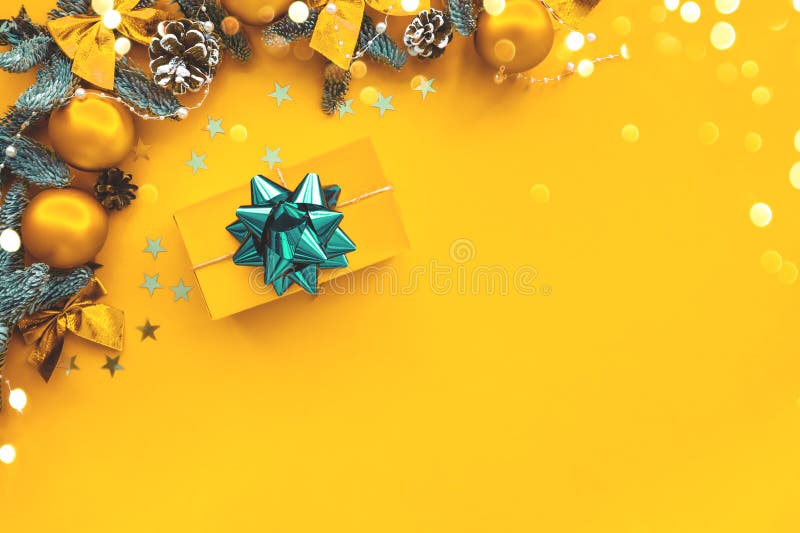 Christmas composition. Gold background with gift box and decorations.