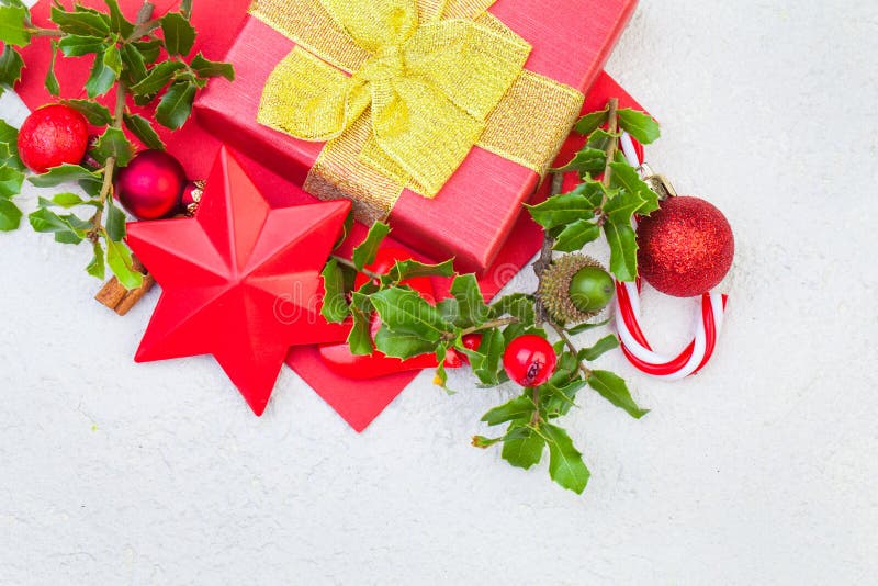 Christmas composition. Xmas gift box, holly berries and red decorations stock photos Christmas composition. Xmas gift box, holly berries and red decorations stock photos
