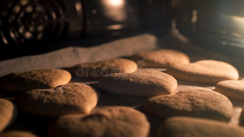 Christmas cookies baking in the oven. Christmas baking. Gingerbread biscuits.