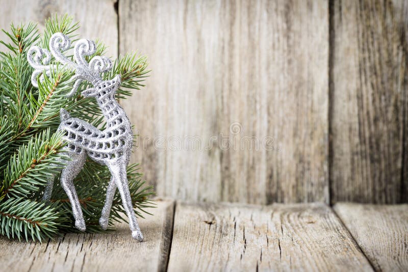 Christmas decoration with fir branches on the wood background.