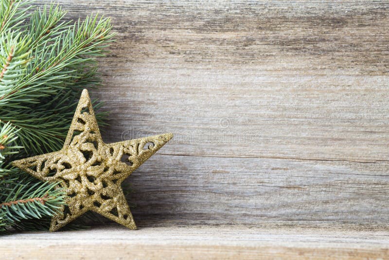 Christmas decoration with fir branches on the wood background.