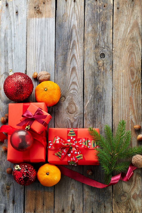 Christmas decoration with gift box over old wooden background.