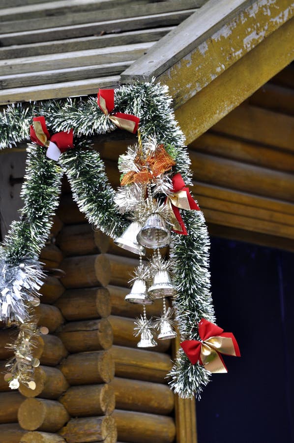 Christmas decoration hanging on wooden house roof