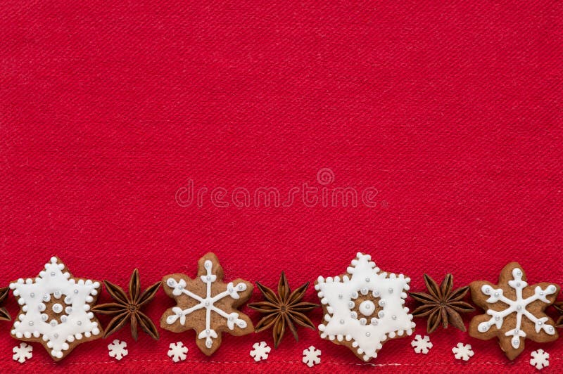 Christmas decoration on a red fabric background. Christmas cookies in the shape of snowflakes handmade