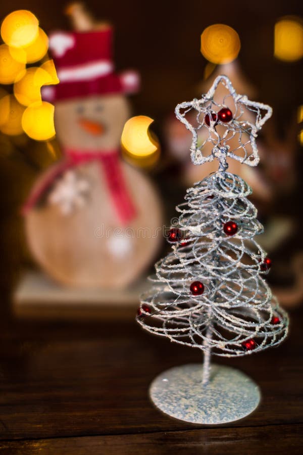 Christmas Decorations Against Blurred Background. Small Silver Wire
