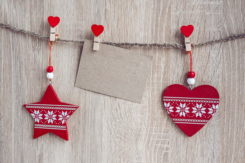 Christmas decorations with a blank card hanging over wooden back