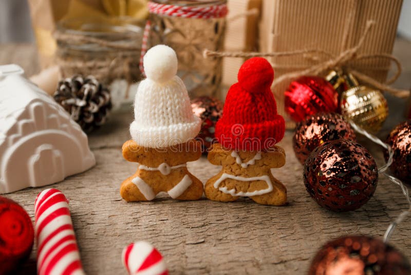 Christmas Decorations with Gingerbread man, candy cane, gift box, festive decorative toy. Hygge rustic xmas decorative background.