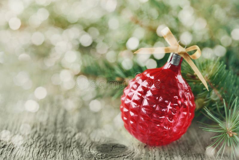 Christmas decorations with red Christmas ball and fir branches on wooden background with magic bokeh effect, Christmas card with royalty free stock photos Christmas decorations with red Christmas ball and fir branches on wooden background with magic bokeh effect, Christmas card with royalty free stock photos