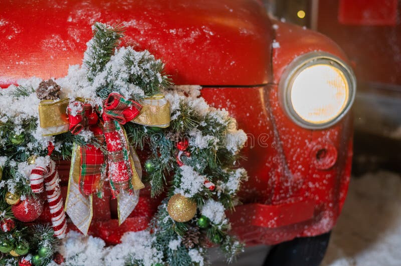 Christmas Decorations on a Red Classic Car Outdoors. Santa Claus Car