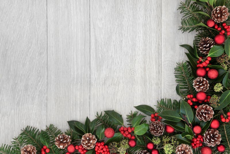 Christmas background border decoration with red baubles, holly, ivy, fir leaf sprigs and pine cones. Christmas background border decoration with red baubles, holly, ivy, fir leaf sprigs and pine cones.