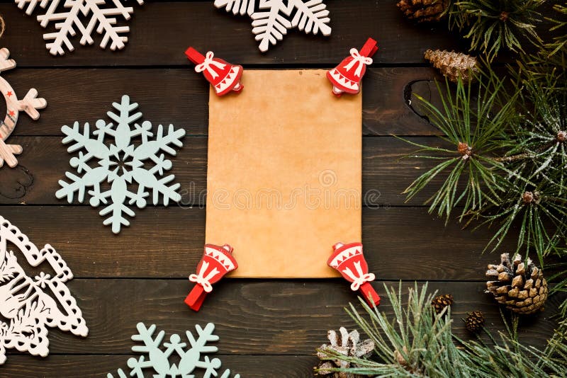 Christmas holiday decorations on a dark wooden background, copy space flat lay. Rest, miracle.