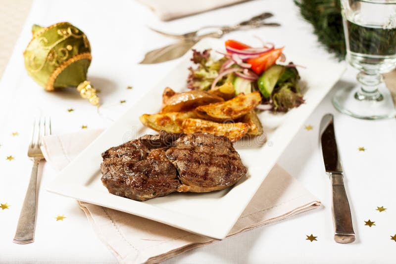 Christmas Dinner. Beef Steak with Roasted Potatoes Stock Photo Image