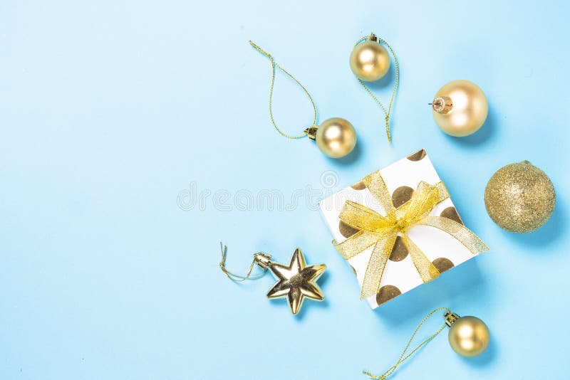 Christmas flatlay background - silver and gold decorations on bl. Christmas flatlay background. Silver and gold christmas decorations and present box on blue royalty free stock image Christmas flatlay background - silver and gold decorations on bl. Christmas flatlay background. Silver and gold christmas decorations and present box on blue royalty free stock image