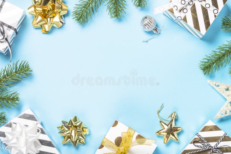 Christmas flatlay background - silver and gold decorations on bl. Christmas flatlay background. Silver and gold christmas decorations and present box on blue stock photo Christmas flatlay background - silver and gold decorations on bl. Christmas flatlay background. Silver and gold christmas decorations and present box on blue stock photo
