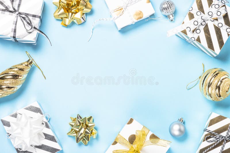 Christmas flatlay background - silver and gold decorations on bl. Christmas flatlay background. Silver and gold christmas decorations and present box on blue royalty free stock photo Christmas flatlay background - silver and gold decorations on bl. Christmas flatlay background. Silver and gold christmas decorations and present box on blue royalty free stock photo