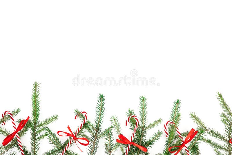 Christmas frame with fir branches and red decoration on white background. Flat lay, top view