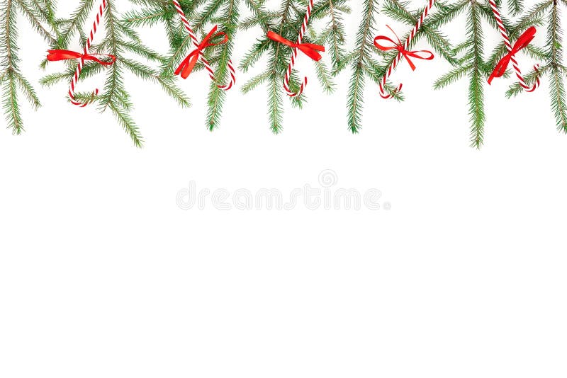 Christmas frame made of fir branches and red decoration on white background. Flat lay, top view