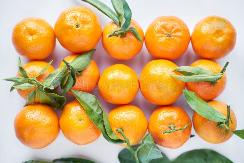 Premium Photo  Christmas fruit. orange fresh tangerines or mandarines with  green leaves in a paper bag lie.