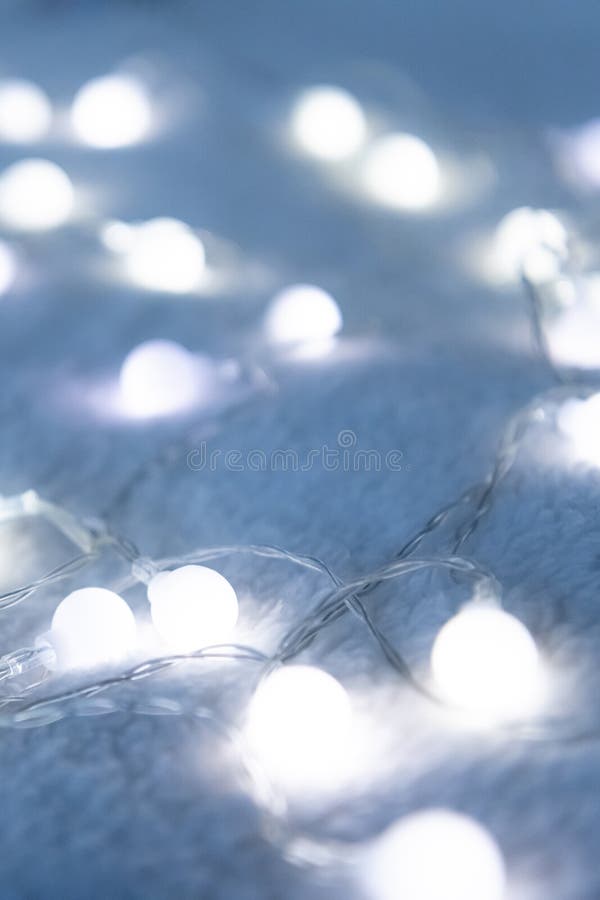 Christmas Garland Lights from LED Bulbs on the Carpet Background Stock