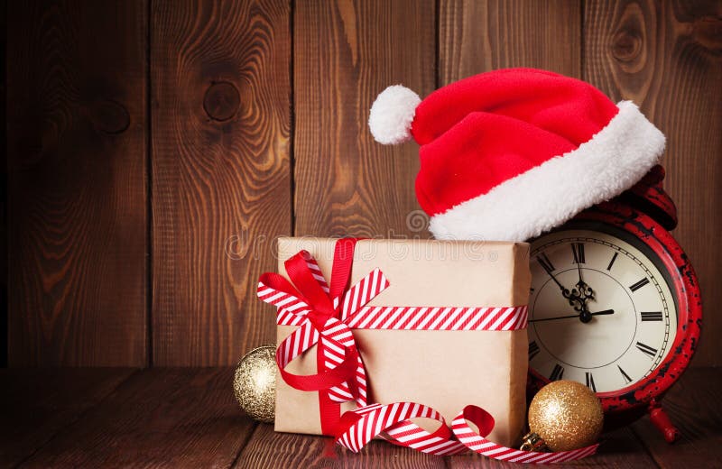 Christmas gift box, alarm clock and santa hat