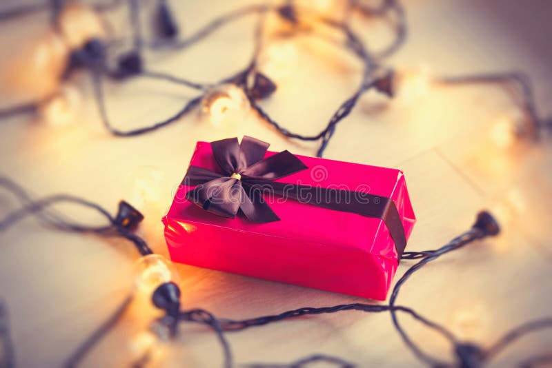 Christmas Gift Box and Pile of Books with Fairy Lights Stock Image