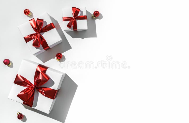 Christmas gift boxes with red ribbon and decoration on white background with bokeh, light. Xmas and Happy New Year holiday