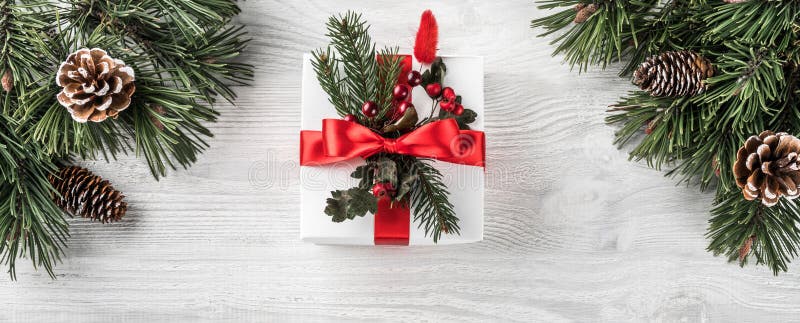 Christmas gift boxes on white wooden background with Fir brancheChristmas gift boxes on white wooden background with Fir branches, royalty free stock image Christmas gift boxes on white wooden background with Fir brancheChristmas gift boxes on white wooden background with Fir branches, royalty free stock image