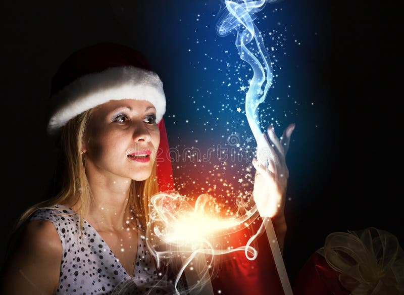 Christmas gift. Santa woman in hat opening box with present stock images Christmas gift. Santa woman in hat opening box with present stock images