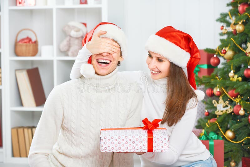 Christmas gift. woman gives a man gift present box