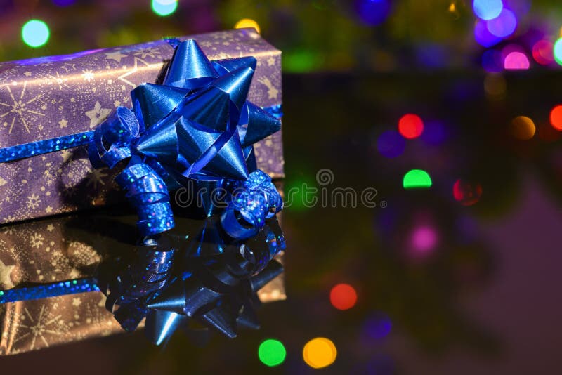 Christmas Gift Wrapped in Purple Wrapping Paper Bound with Blue Ribbon ...