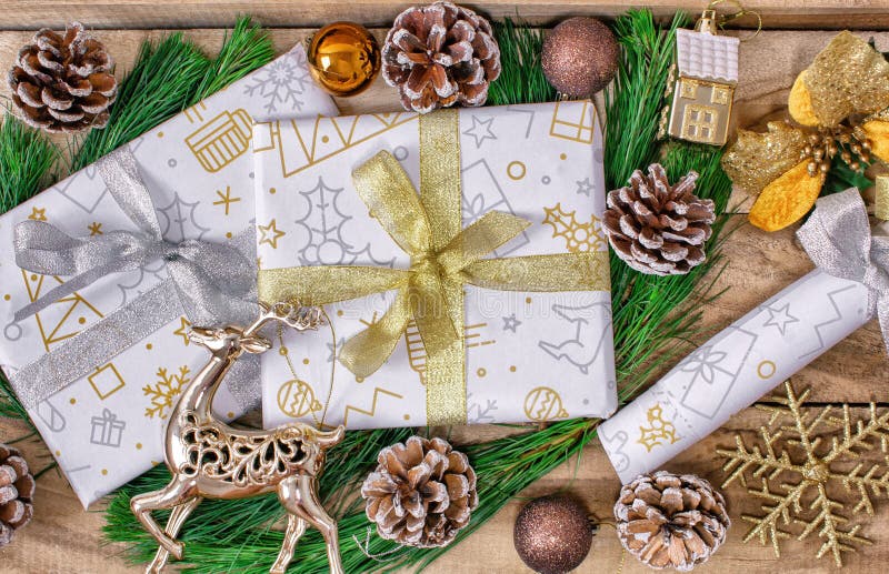 Christmas gifts, boxes of gifts, fir, with cones and deer on a wooden background. stock images Christmas gifts, boxes of gifts, fir, with cones and deer on a wooden background. stock images