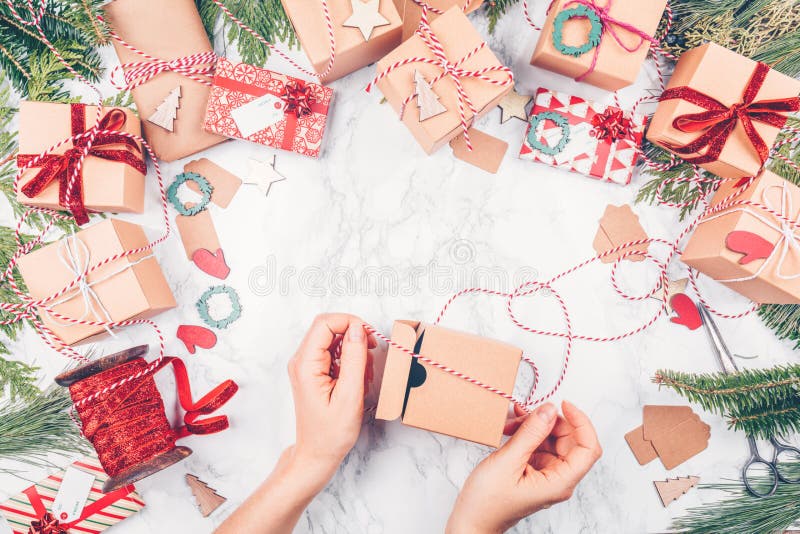 Christmas gifts and ribbons on white marble background, the woman packs Christmas gifts stock photography Christmas gifts and ribbons on white marble background, the woman packs Christmas gifts stock photography