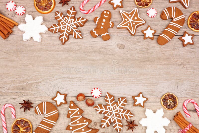 Christmas gingerbread cookies, candy and baking items, double border on a wood background