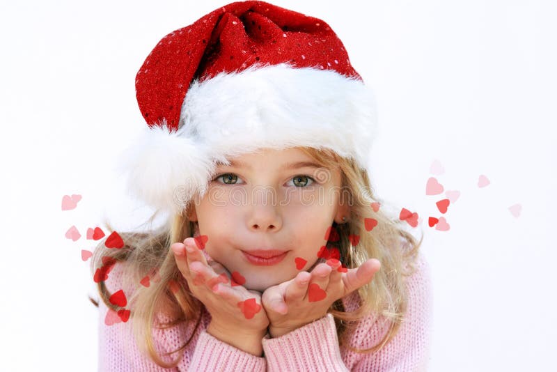 A cute little girl sporting a Santa hat and blowing red love heart kisses. A cute little girl sporting a Santa hat and blowing red love heart kisses.