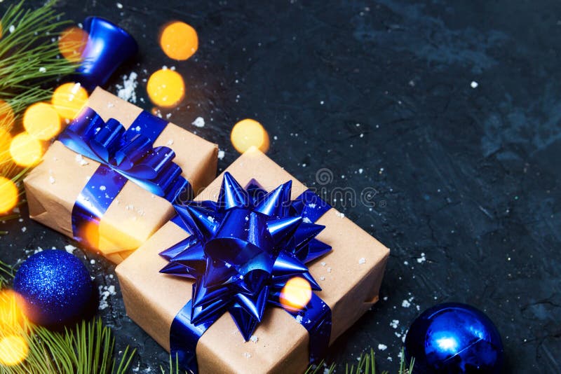 Christmas greeting card composition. Gift with blue christmas tree and balls decoration with light on dark background. Top view, royalty free stock photos Christmas greeting card composition. Gift with blue christmas tree and balls decoration with light on dark background. Top view, royalty free stock photos
