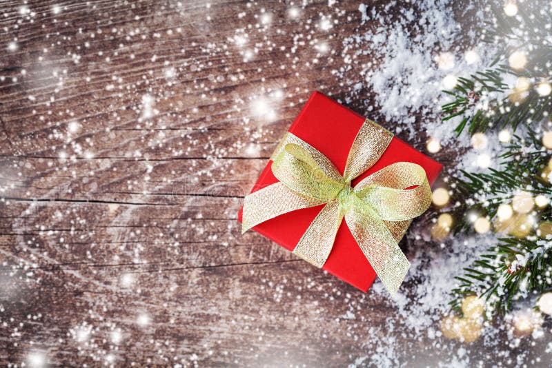 Christmas greeting card. Gift or present box and snowy fir branches on rustic background royalty free stock image Christmas greeting card. Gift or present box and snowy fir branches on rustic background royalty free stock image