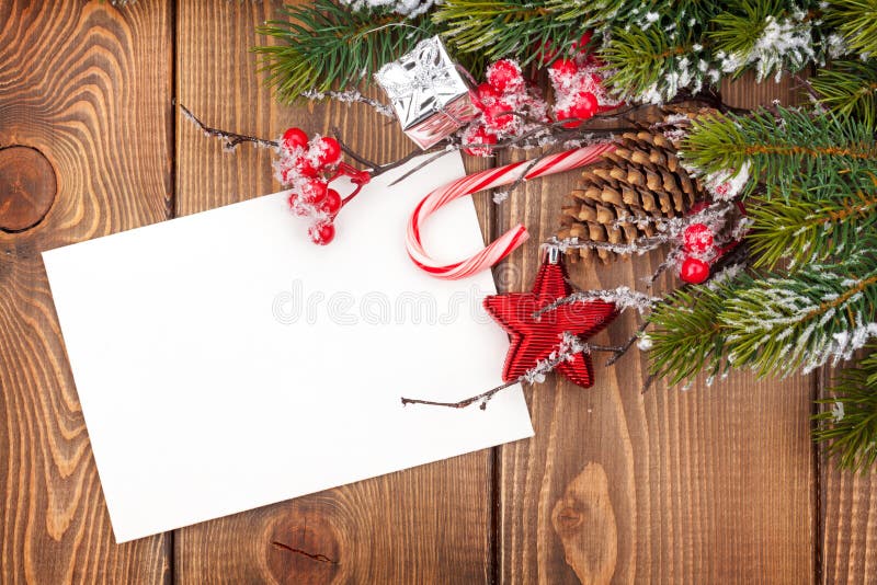 Christmas greeting card or photo frame over wooden table with sn