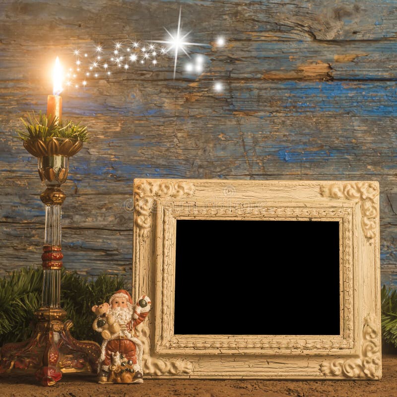 Christmas greeting photo frame card, old empty photo frame, vintage candlestick and Santa figurine