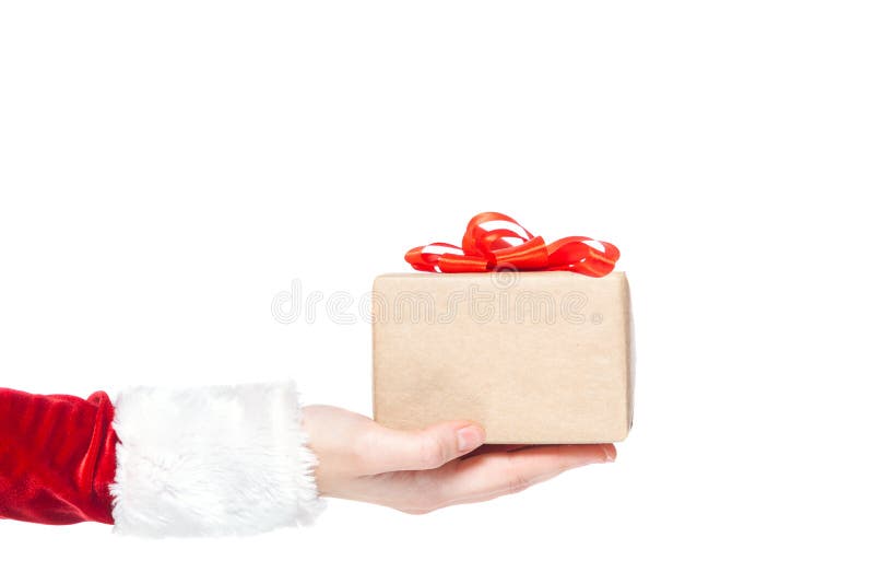 Christmas. Hand of a woman in a Santa Claus costume holding a gift box present tied with a red ribbon with a bow