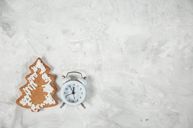 Christmas holiday background with alarm-clock, Candy canes plastering background. Close-up, top view royalty free stock photo