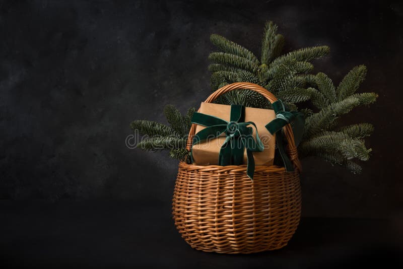 Christmas holiday gift hamper with craft gift and evergreen spice branches on black