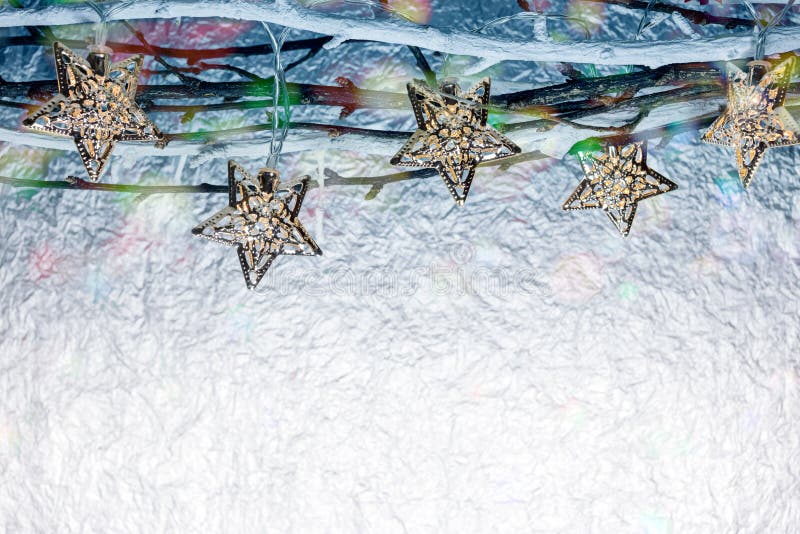 Christmas Holiday Lights Hanging on Bare Branches Against Blurred