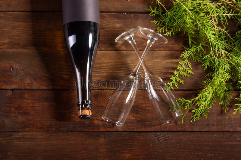 Christmas holiday table with glasses and a bottle of wine of champagne