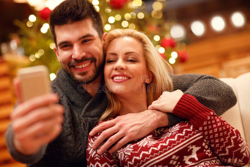 Christmas, holidays, technology and people concept - couple taking selfie. royalty free stock photo Christmas, holidays, technology and people concept - couple taking selfie. royalty free stock photo
